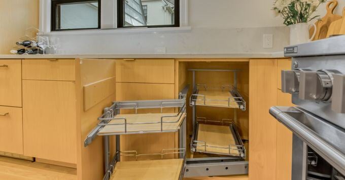 Pull out extra cabinet storage in a natural wood finish