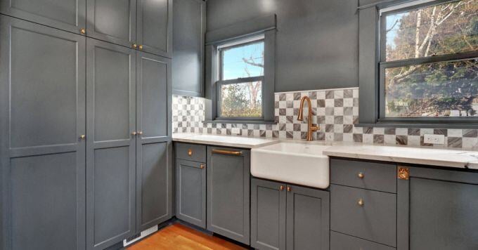 Dusty blue kitchen with checkboard marble backsplash