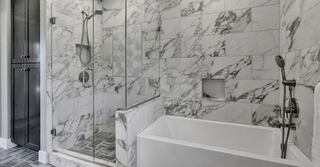 white and black marble shower after bathroom remodel
